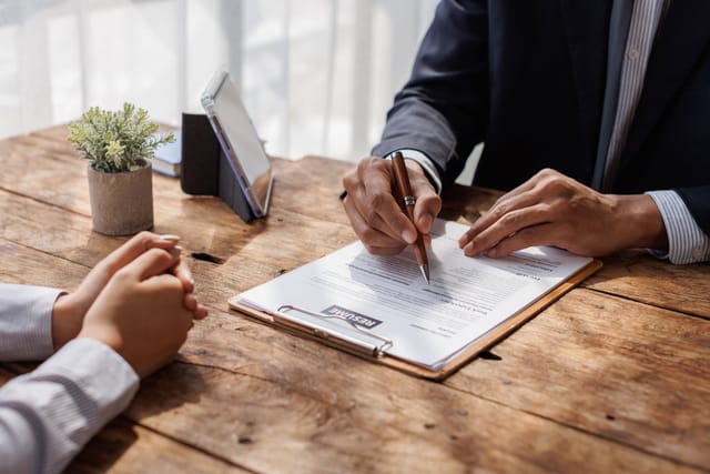 A business owner reviewing paperwork with an insurance agent
